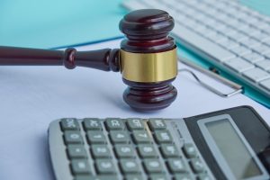 Judge's gavel and dollar banknotes on income tax form background